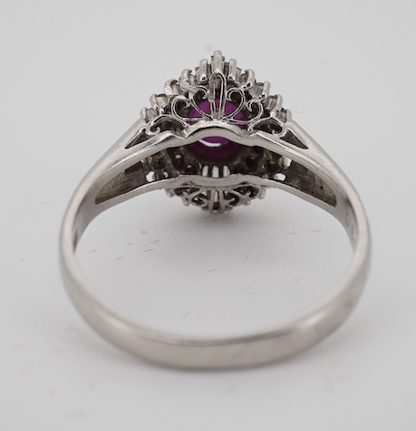 A modern platinum, star ruby and diamond cluster set dress ring, size J/K, gross weight 4.7 grams. Condition - fair to good